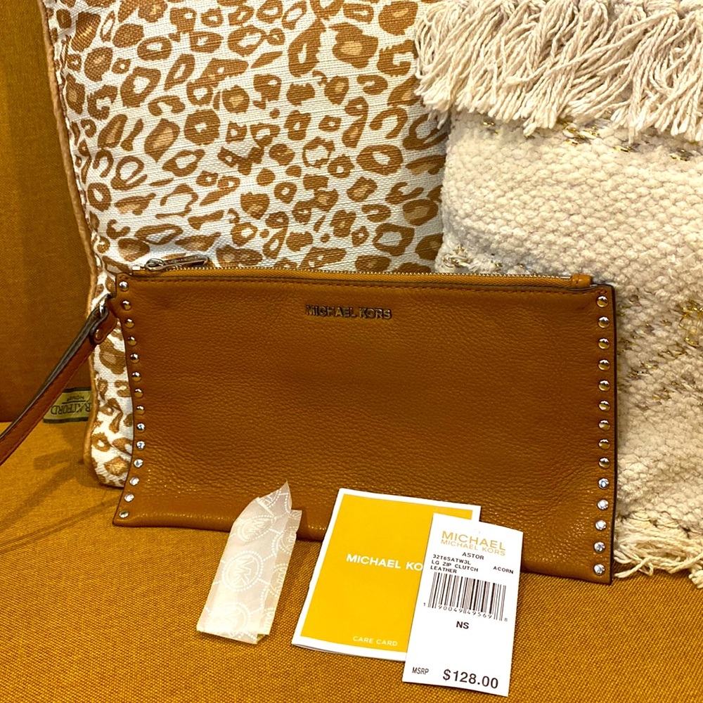 Genuine leather Michael Kors “Astor” wristlet in color “ Acorn”.